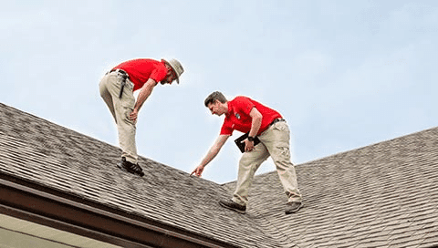 Home inspectors examining a residential roof