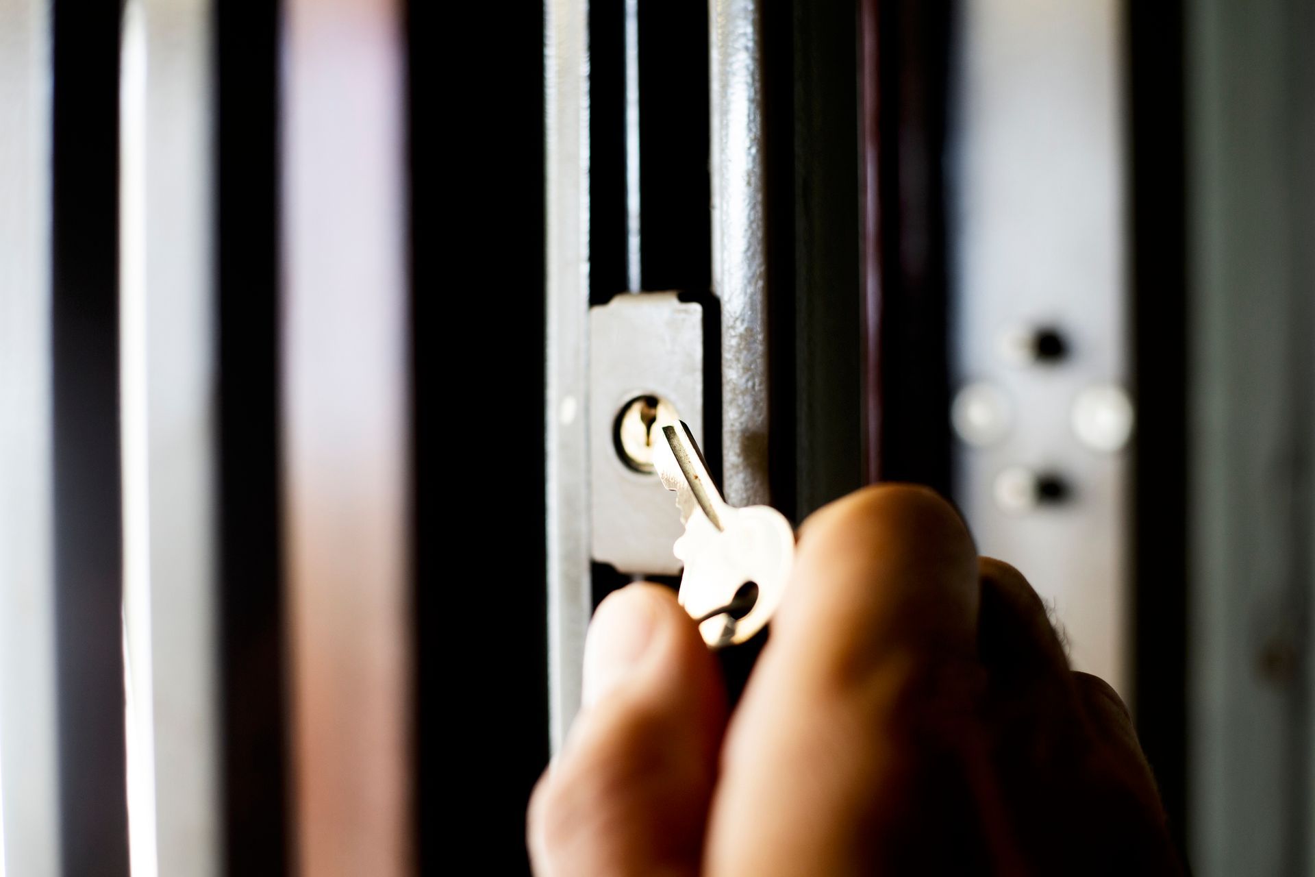 A person is opening a door with a key.