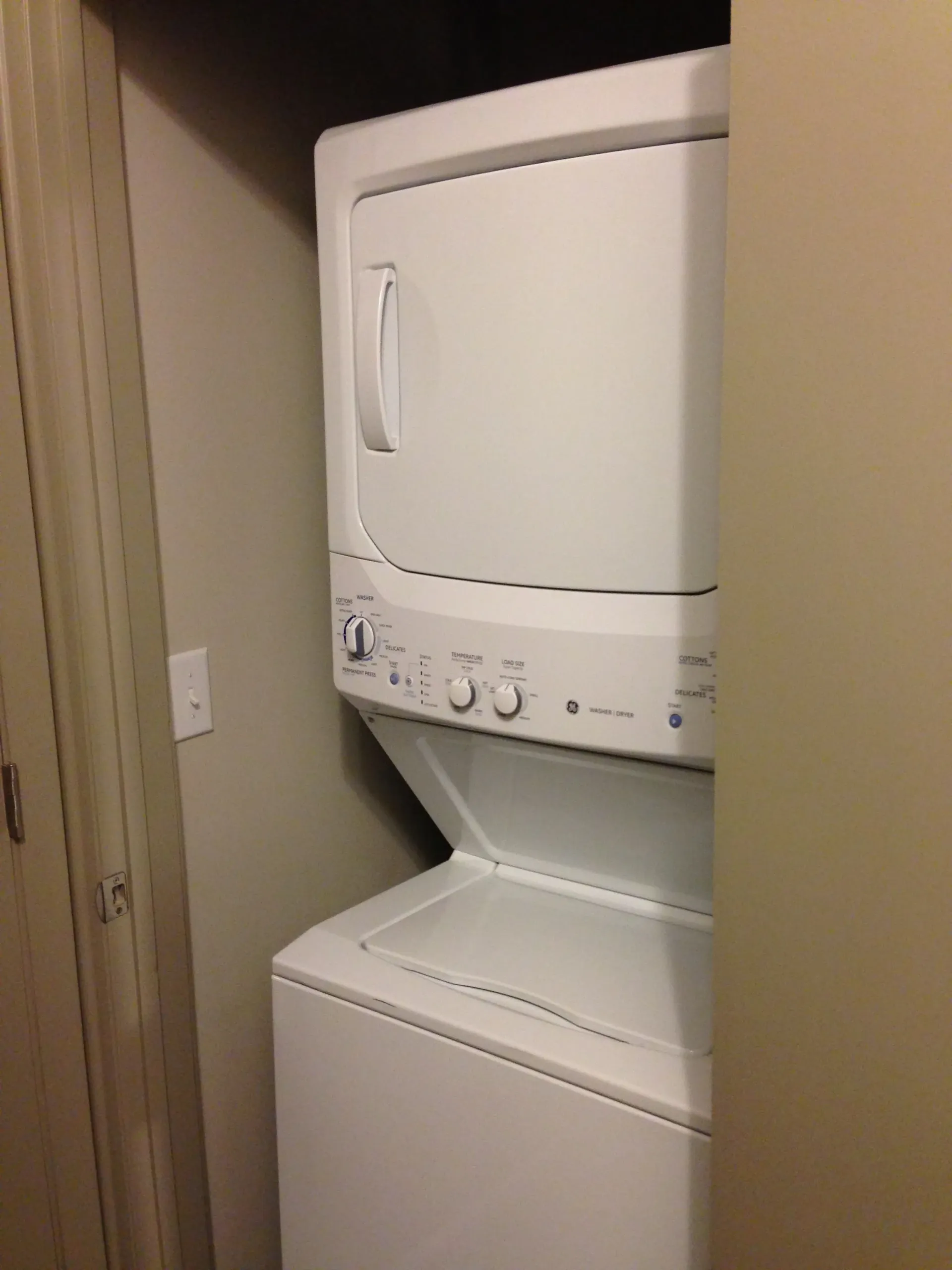 Stackable washer and dryer unit in a closet.