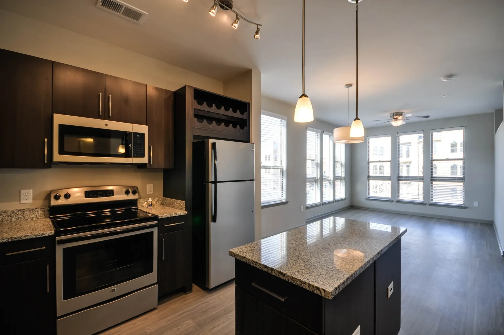 Modern kitchen with stainless steel appliances, granite countertops, and island.