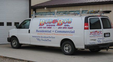 Business Van White Bob-Bob Service truck parked outside building, advertising residential and commercial services.