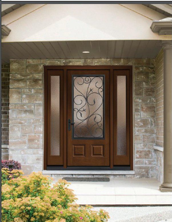 Front porch with a dark wooden front door, frosted glass, and stone exterior walls