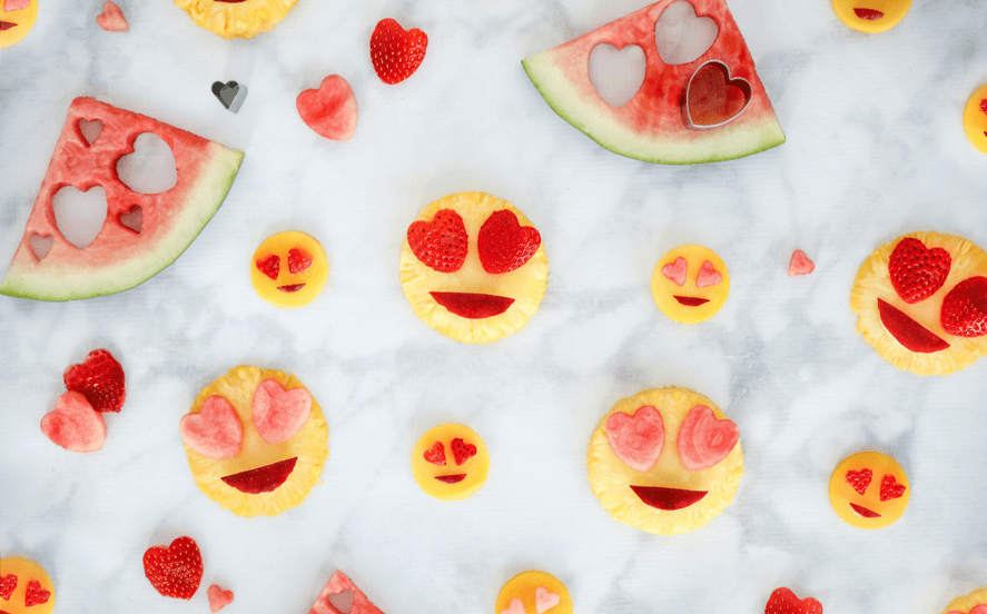 Watermelon slices with hearts in their eyes and smiley faces made out of watermelon slices.