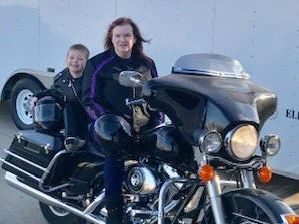 Katherine Terry of Wheat State Insurance Group pictured on motorcycle with her grandchild