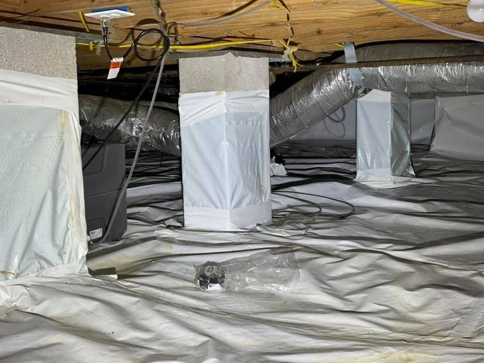 The ceiling of a basement is covered in plastic.