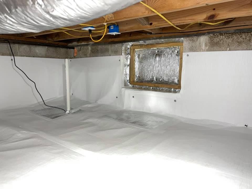 A basement with a window in it and a lot of wires coming out of it.