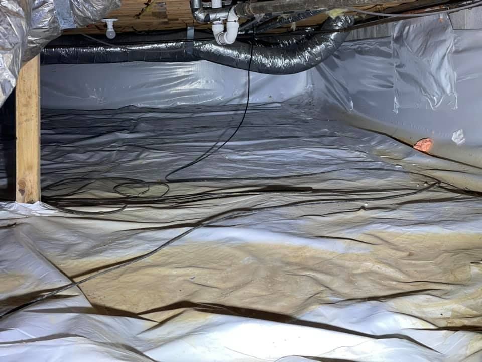 A basement filled with plastic and pipes.