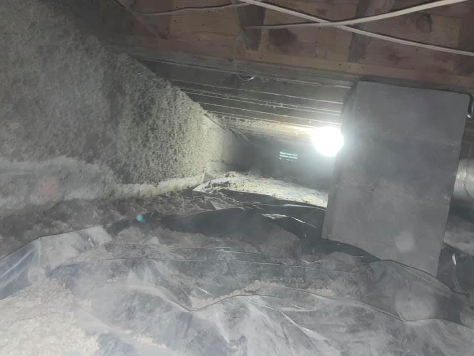 There is a lot of insulation in the attic of a house.