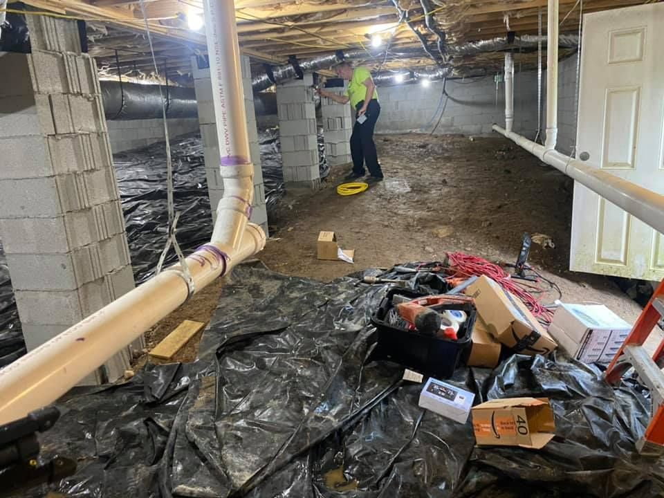 A man is working in a basement under construction.