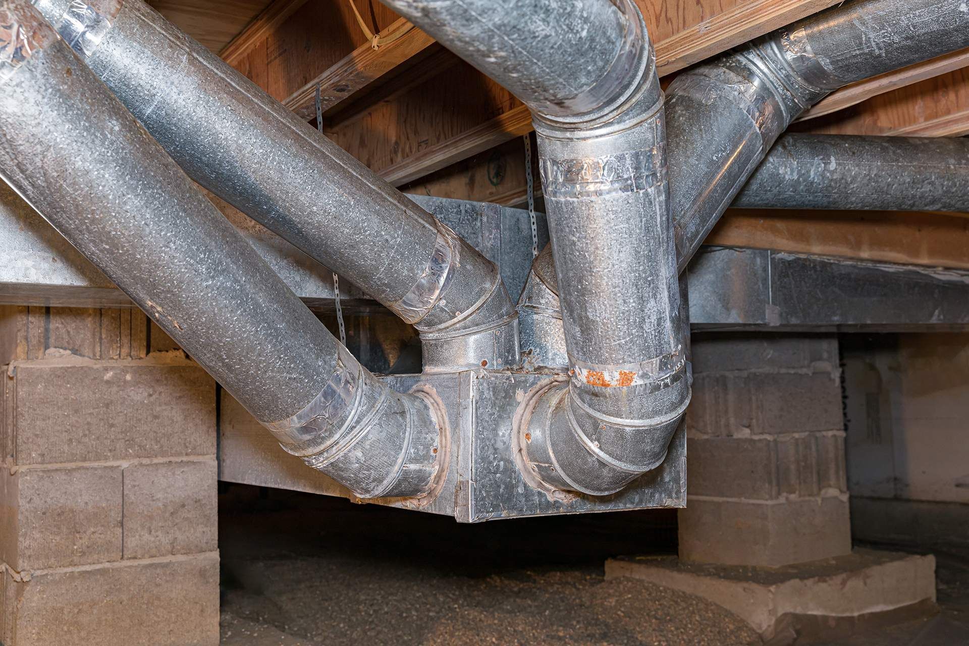 A bunch of pipes are connected to each other in a basement.