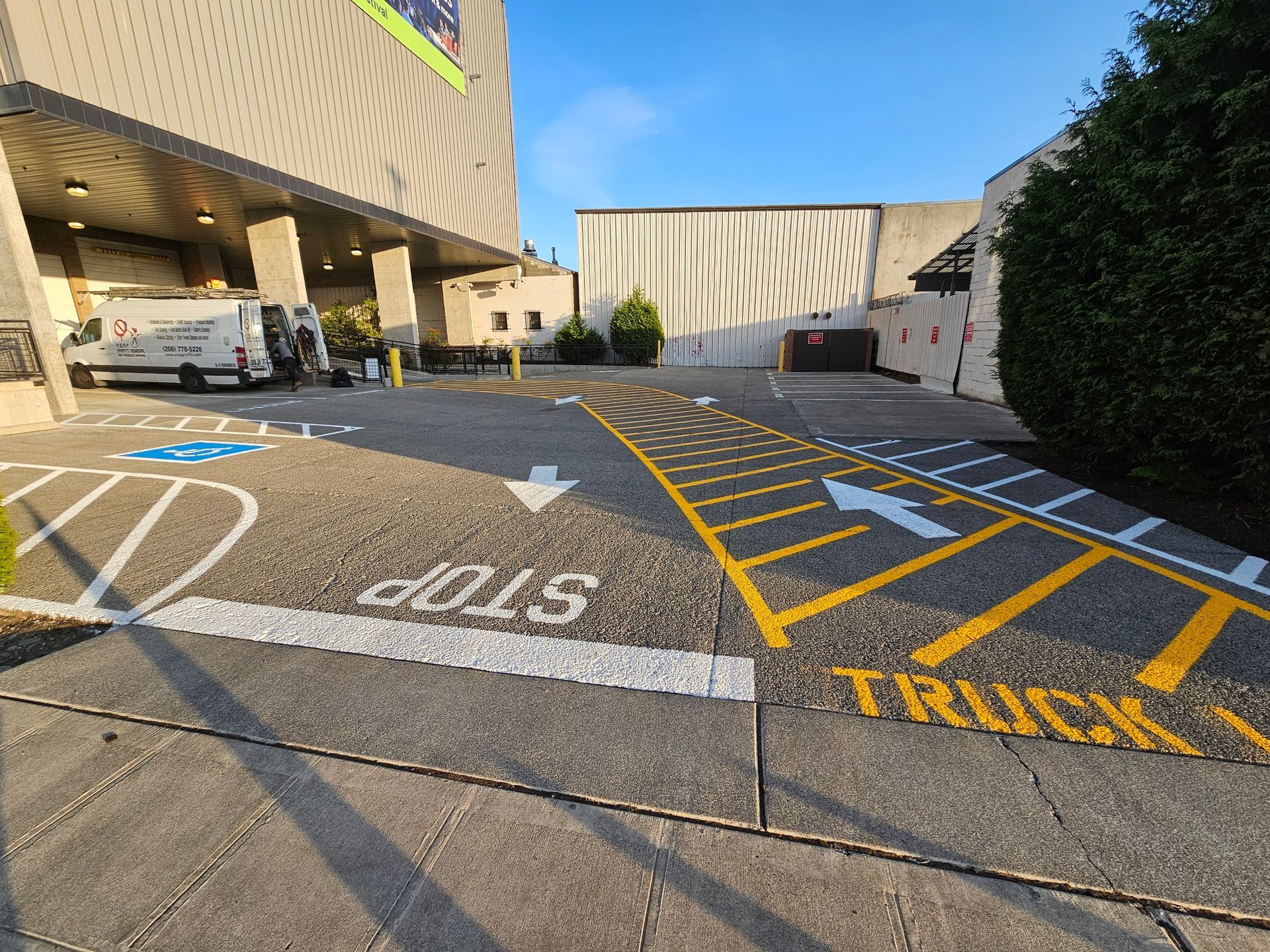 Loading dock area with painted truck lane and accessible parking.
