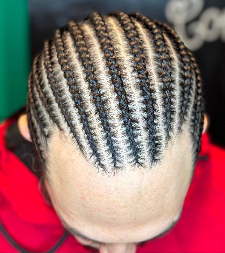 Close-up of a braided hairstyle with neat cornrows on a person's head.