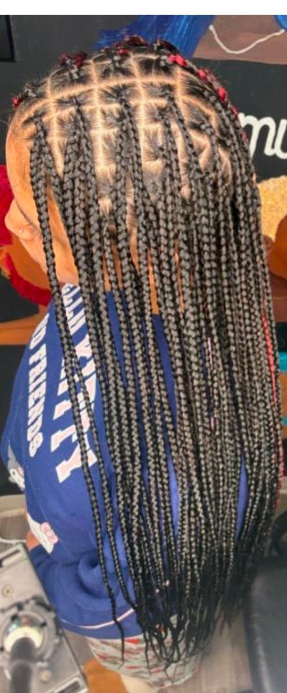 Close-up of long braided hair with blonde highlights and red accents, viewed from above