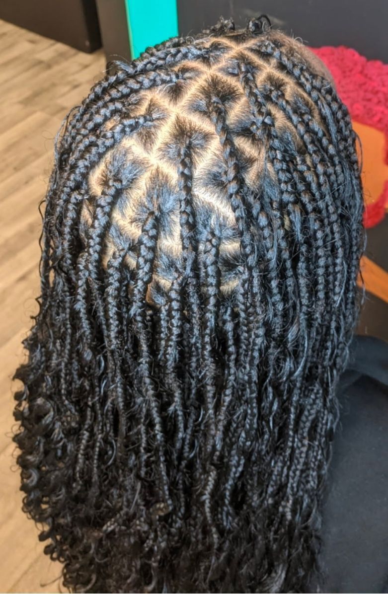 Close-up of neat twisted braids with a visible scalp parting pattern