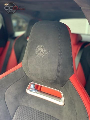 A close up of a car seat with a logo on it.