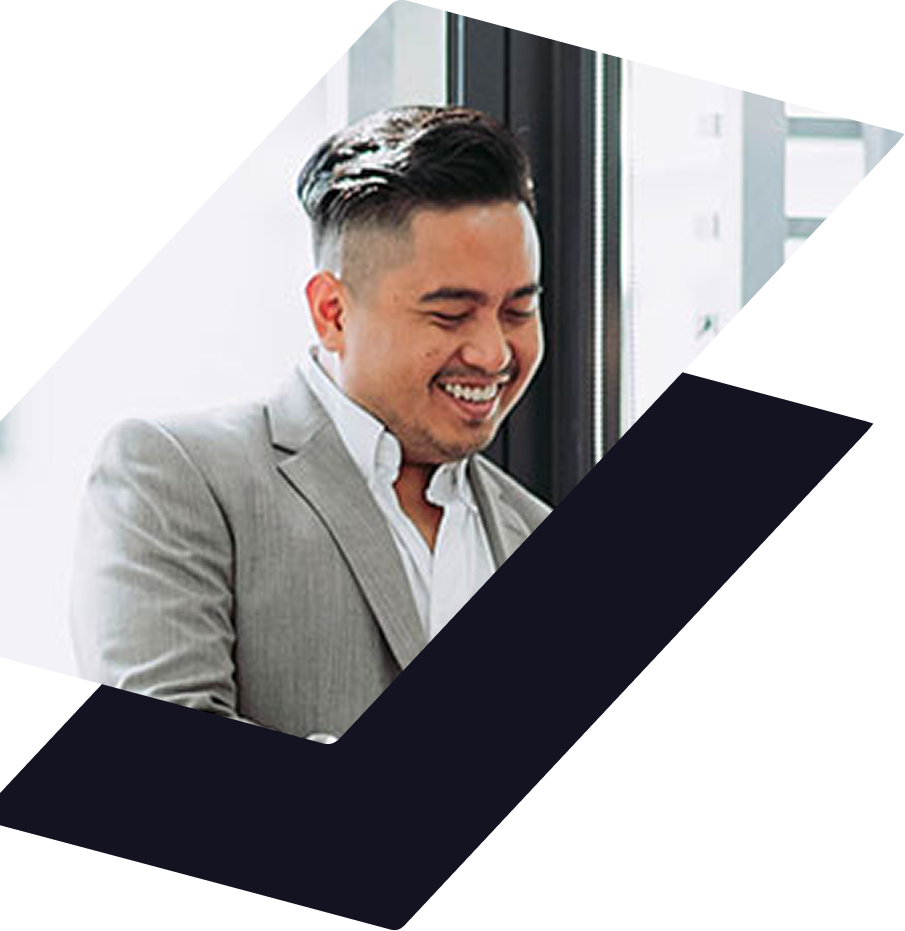 A professional smiling in a light gray suit and white shirt, framed by a dark blue geometric checkmark shape.