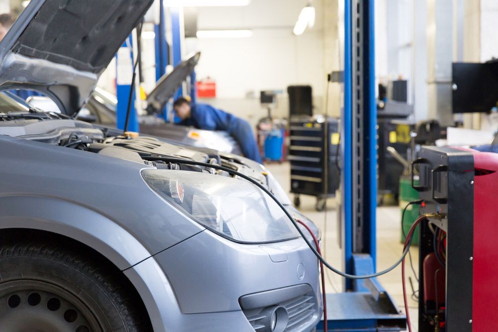 Car Being Repaired In A Garage With The Hood Up — Erina Car Air Conditioning In Gosford, NSW