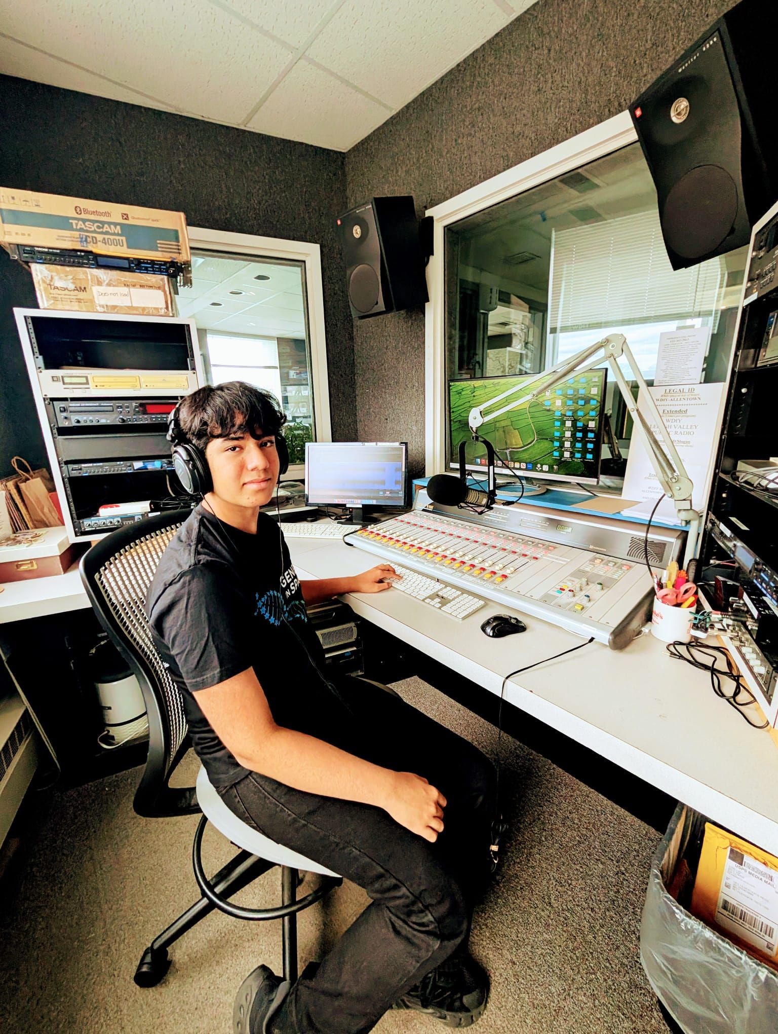 Aryash Shyam, Teen Scientist host, in a professional radio studio