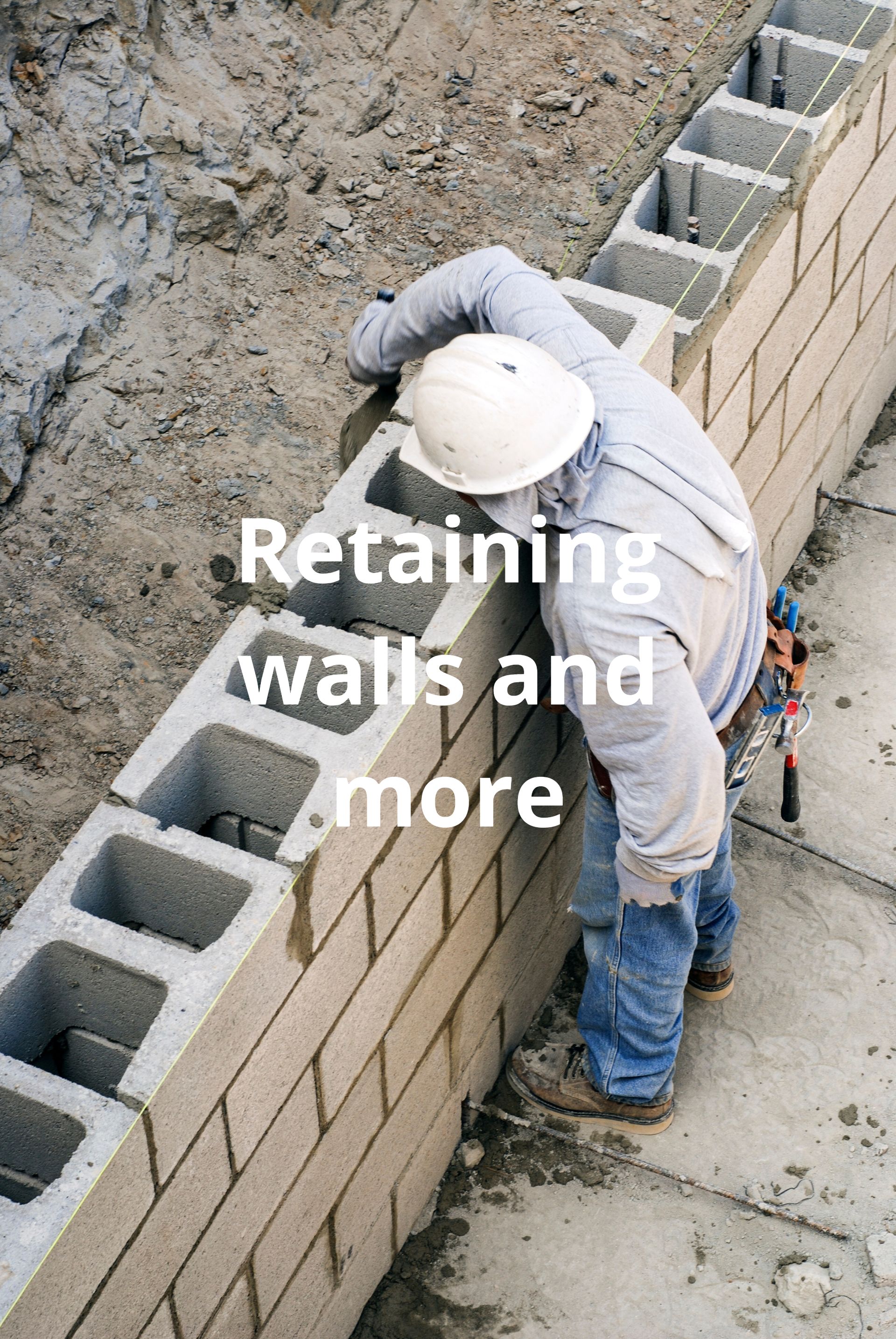 A construction worker is building a brick wall.