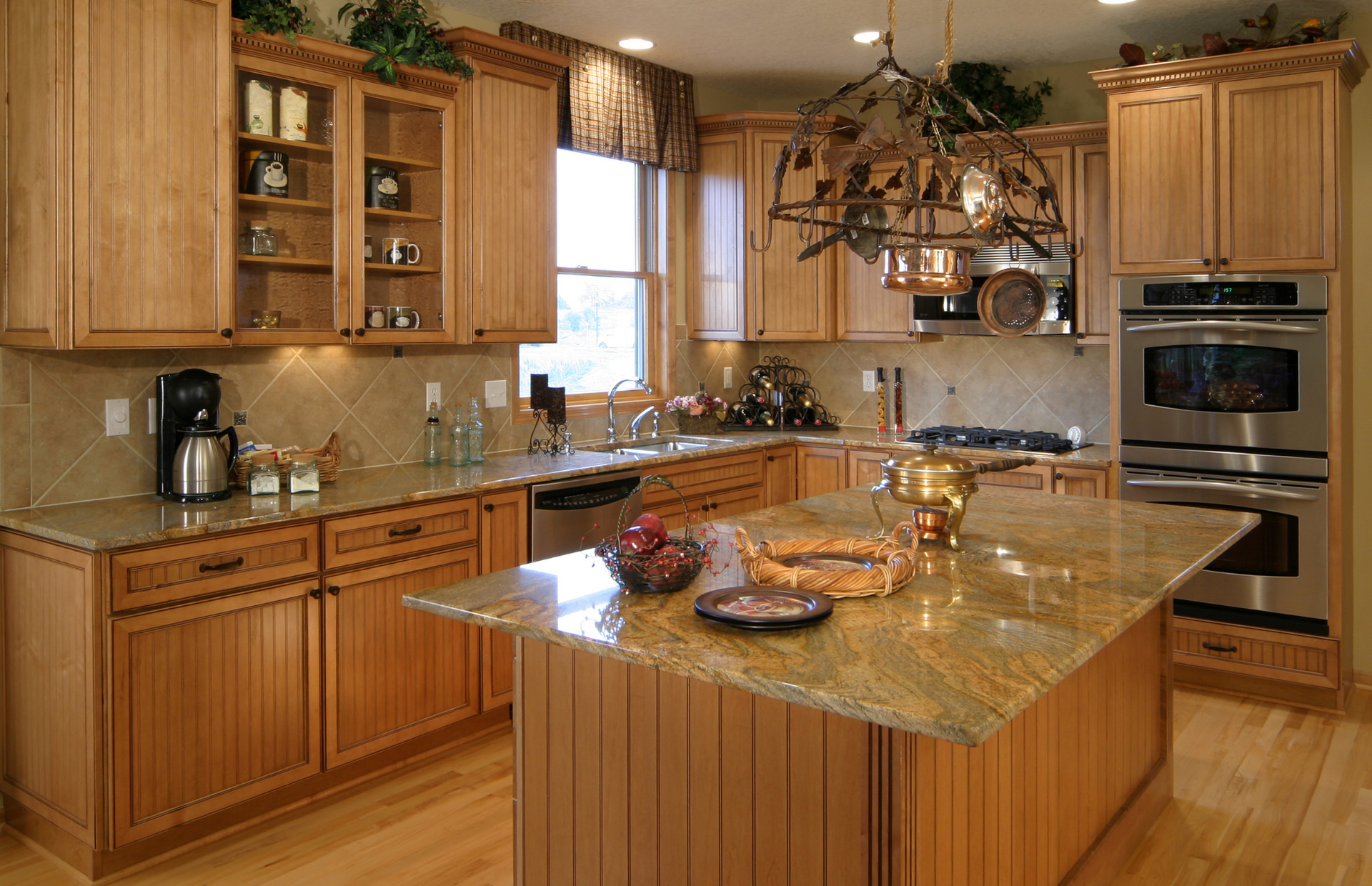 Spacious modern kitchen with wood cabinets, granite island, and stainless steel appliances