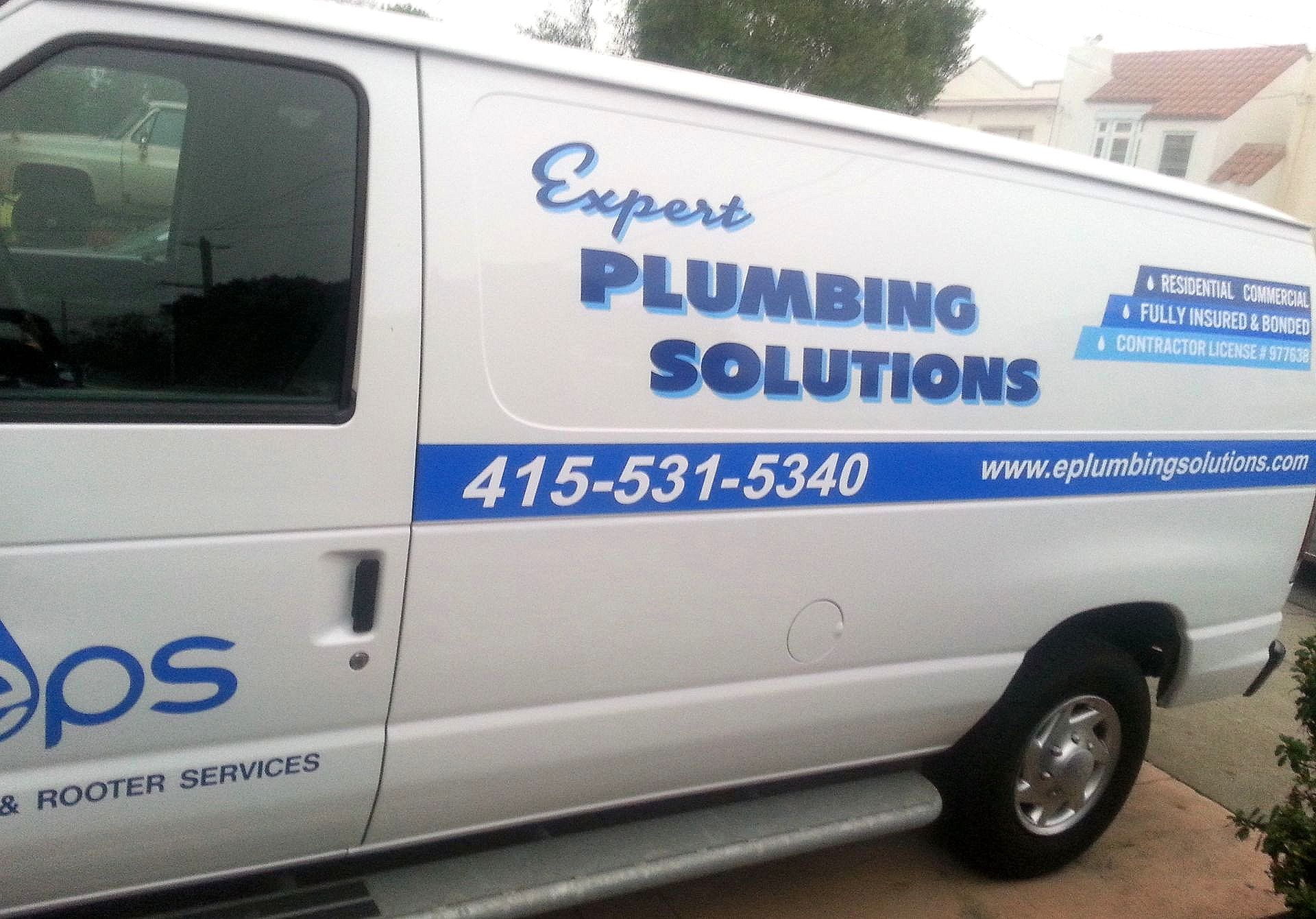 White van with blue text advertising