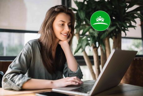 Woman smiling while using her laptop
