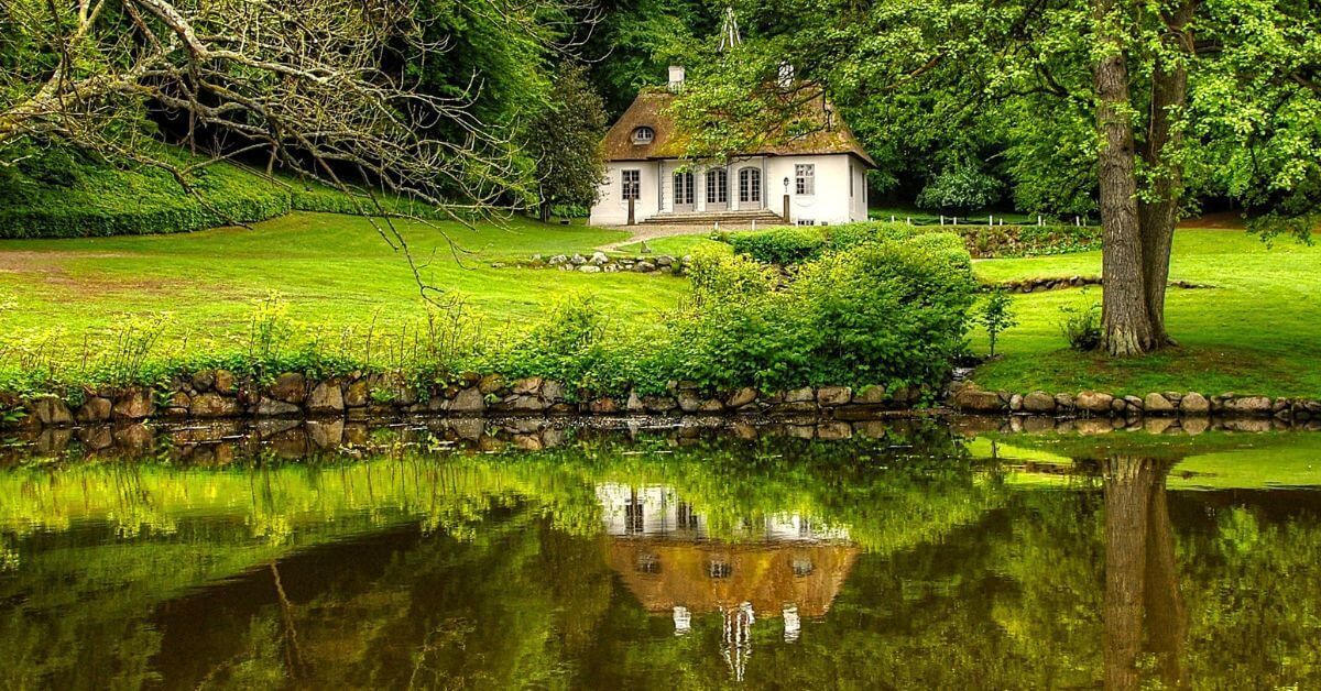 Lush green grass surrounds a building.
