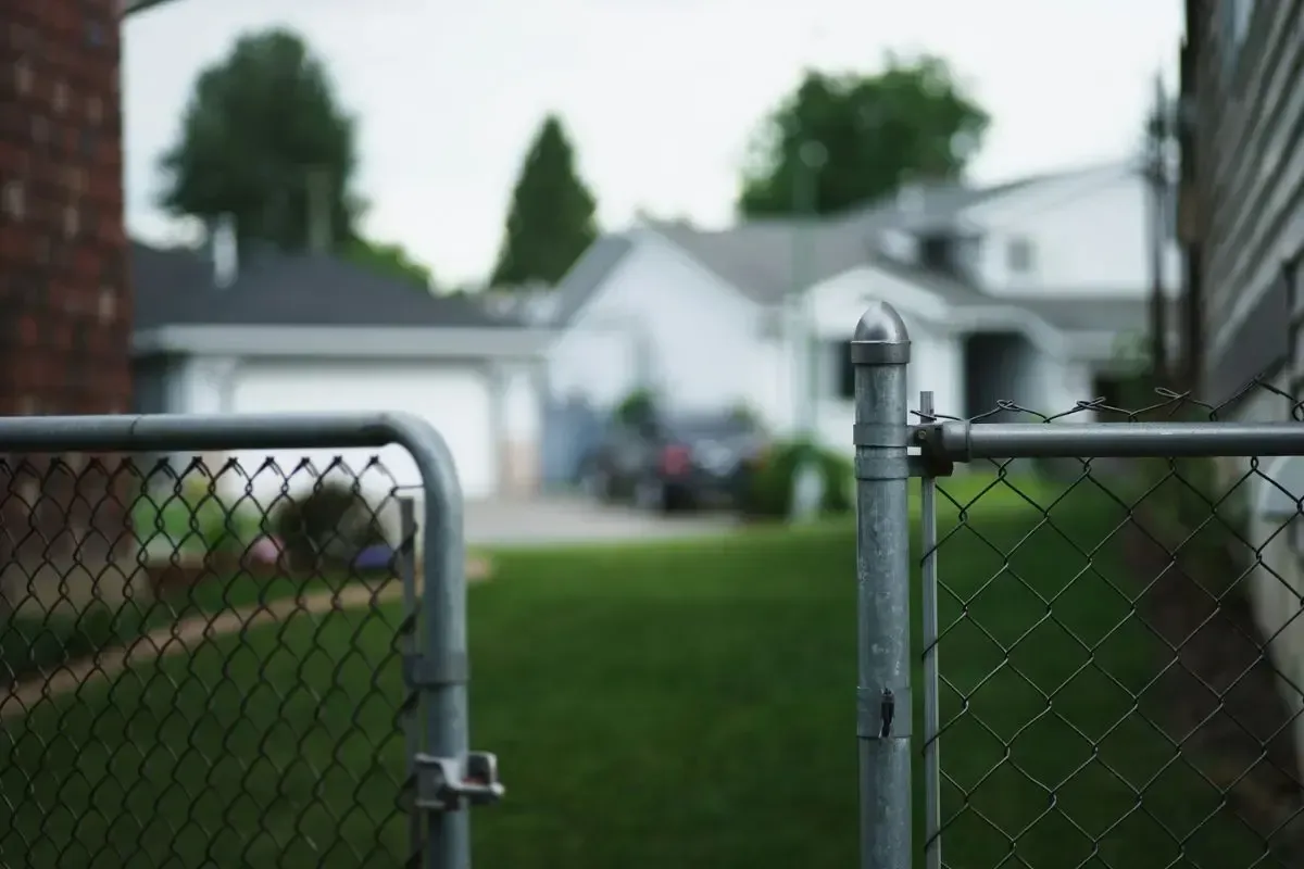 A fence separating a property from a neighbor's house