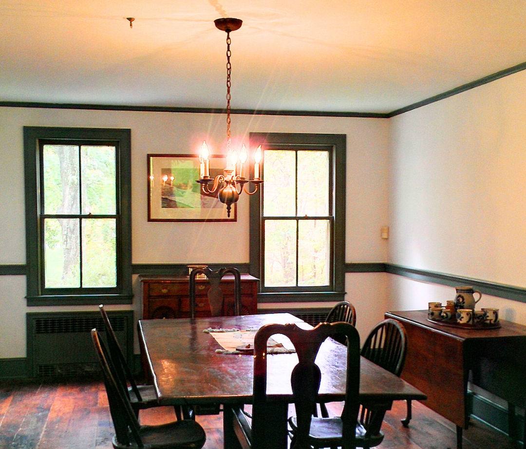A dining room with a table and chairs painted by painters in connecticut