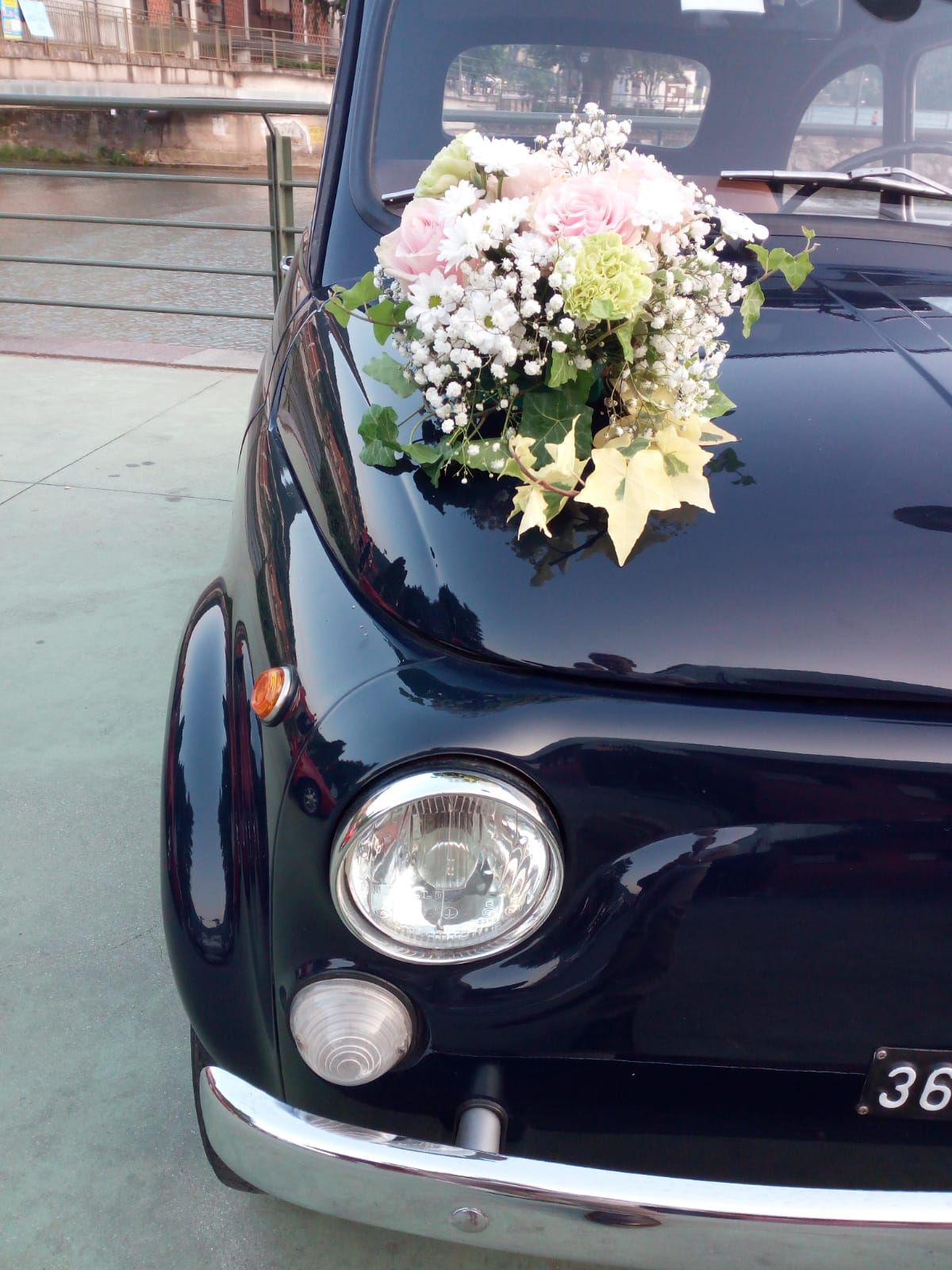 black car with a bunch of flowers on the bonnet