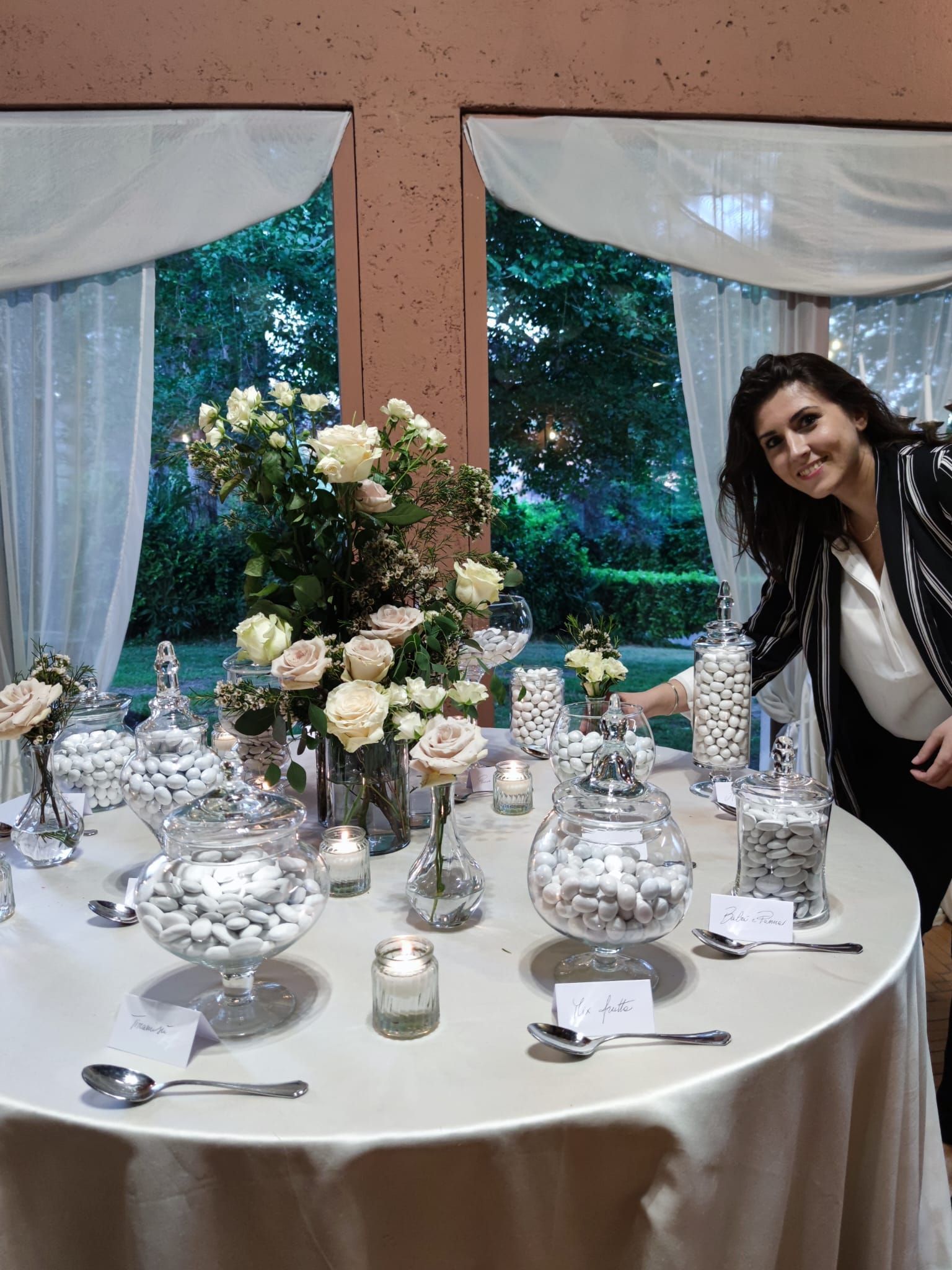 woman standing in front of a table full of confetti and flowers