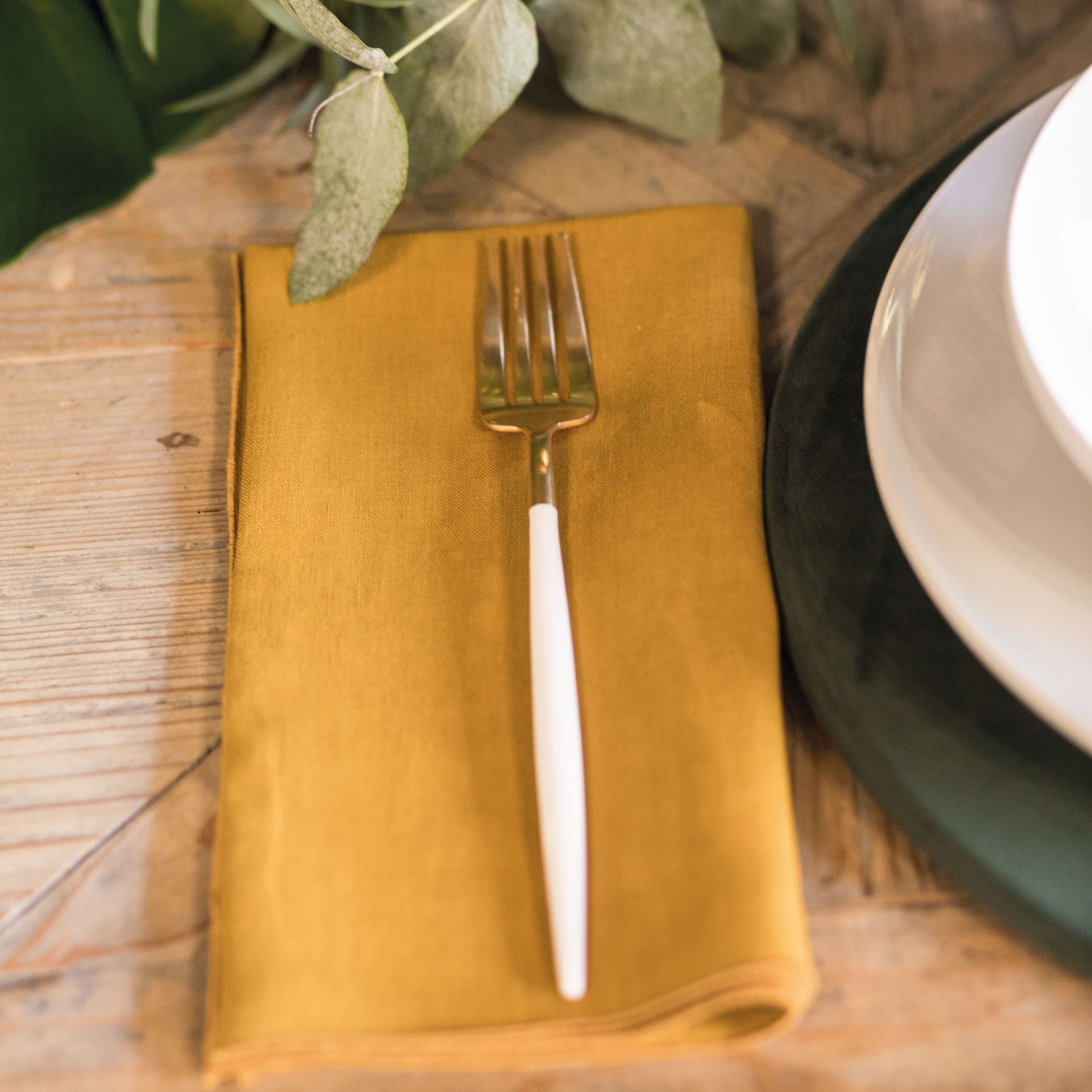 fork on a yellow napkin on a wooden table