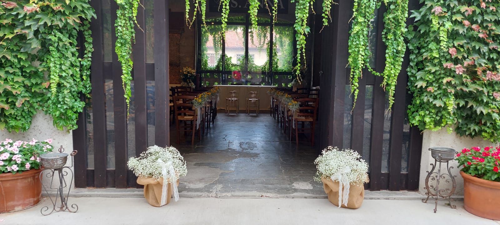the entrance of a church decorated for a wedding ceremony