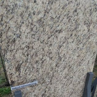 Close-up of a speckled gray granite slab labeled 