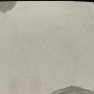 Blank beige paper with a small gray mound visible near the bottom edge
