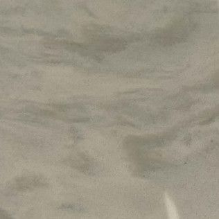 Close-up of light beige sand with subtle ripples and texture