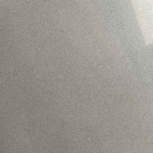 Close-up of a plain gray textured surface with a bright corner highlight