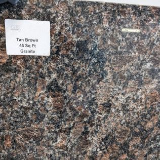 Granite sample with pink, gray, and black speckled pattern, labeled “Tan Brown 45 Sq Ft.”