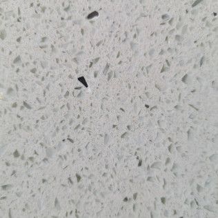 Gray terrazzo floor with a small black fragment near the center