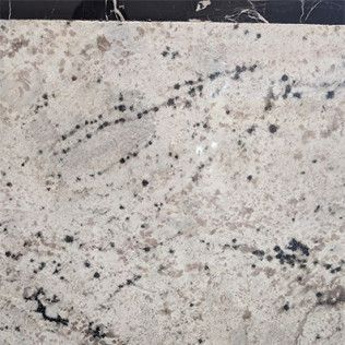 Light gray speckled stone surface with black and dark gray veins and spots