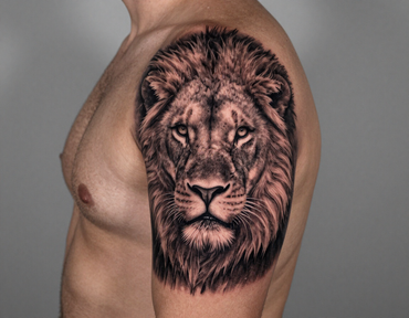 Side view of a torso with a realistic lion tattoo on the upper arm