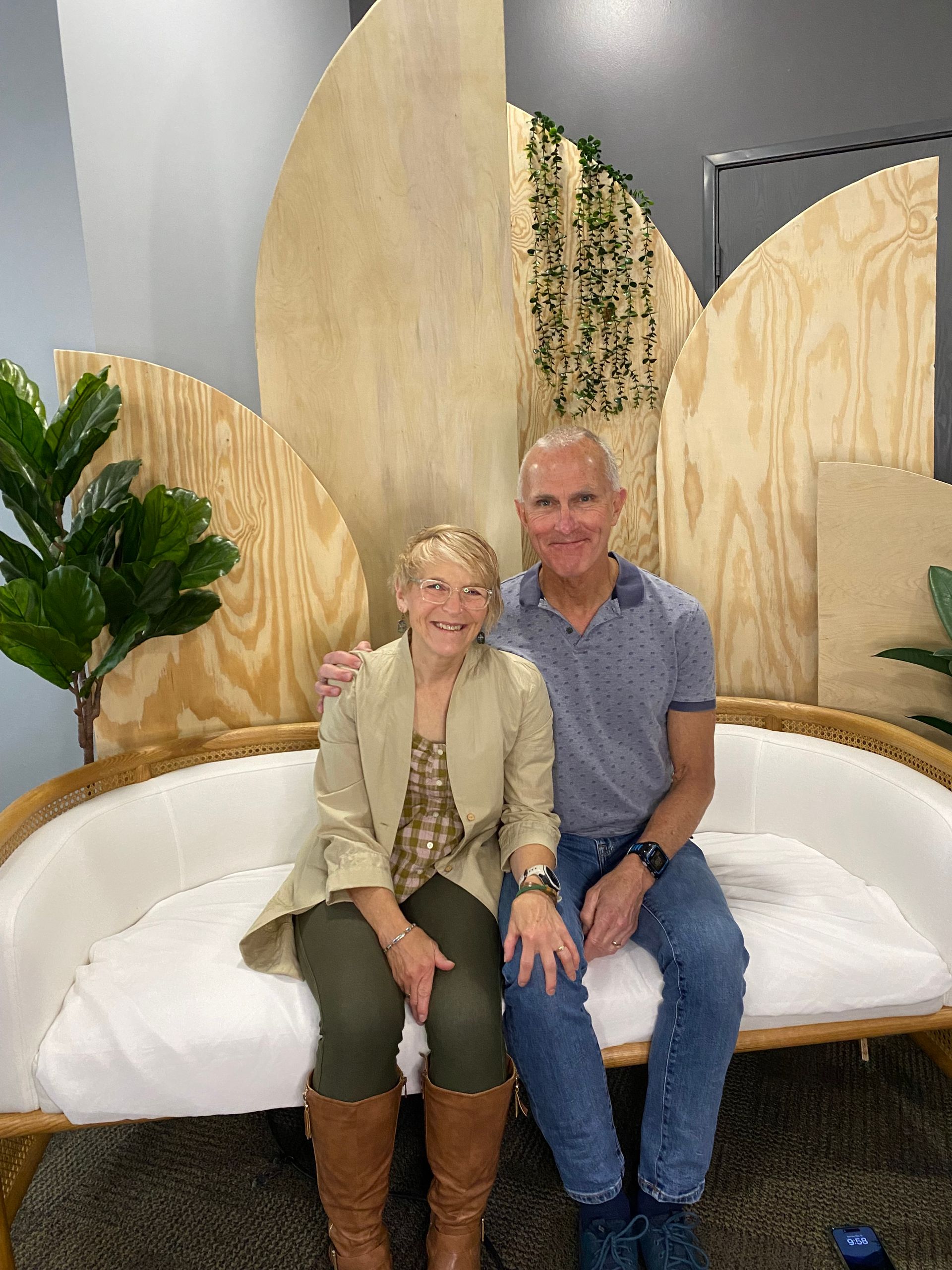 A man and a woman are sitting on a couch.