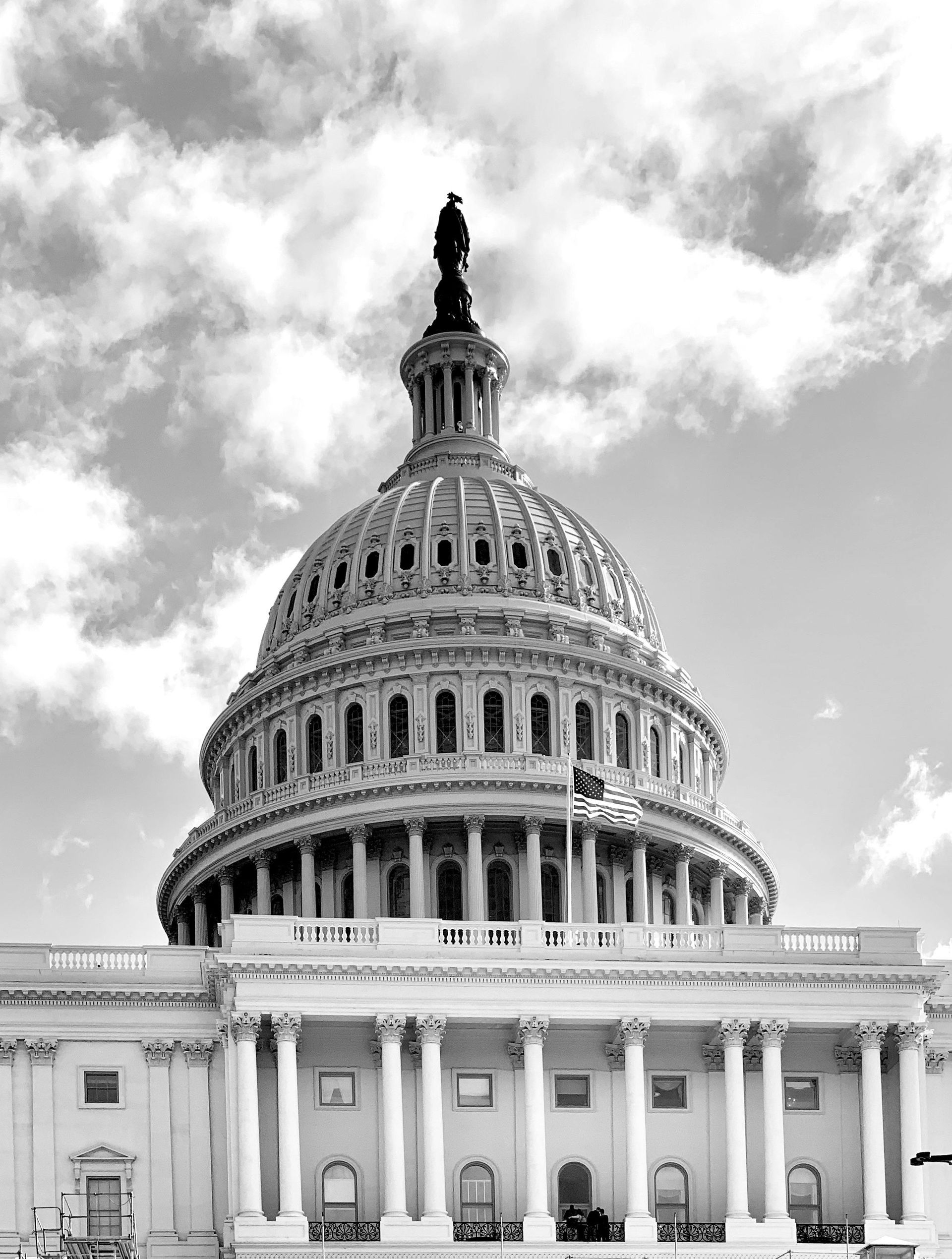United States Capitol Building, Washington, D.C., with cloudy sky background.