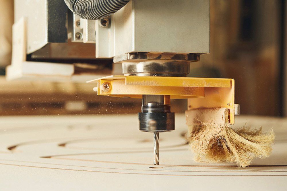 A Machine is Cutting a Piece of Wood With a Drill — Signtek Gladstone in Gladstone Central, QLD