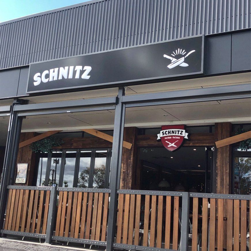 Exterior View of Schnitz Restaurant With a Black Sign — Signtek Gladstone in Gladstone Central, QLD