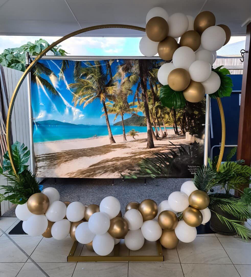 A Balloon Arch With a Picture of a Beach in the Background — Signtek Gladstone in Gladstone Central, QLD