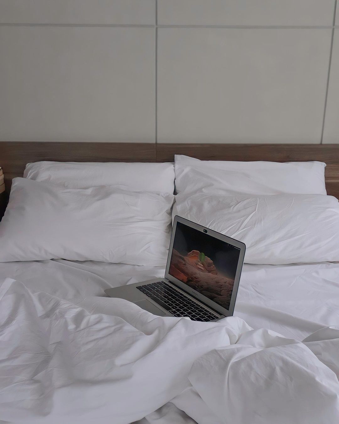 Laptop on white bed at The Sphere Serviced Residences Makati
