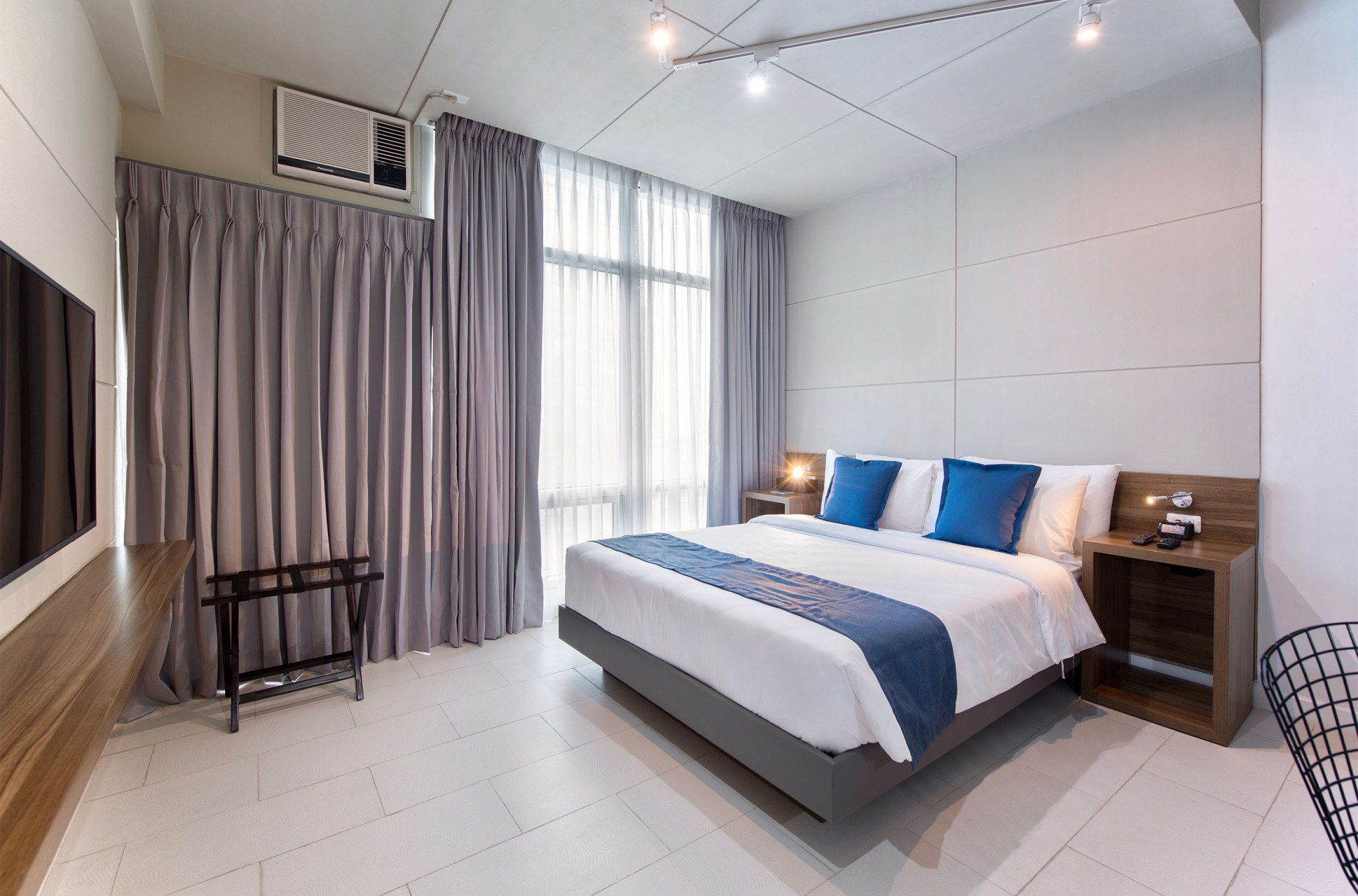 A hotel room with a large bed and a flat screen tv.