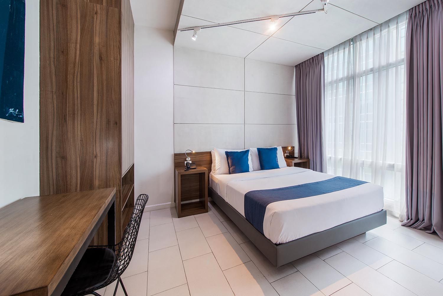 A hotel room with a large bed and a flat screen tv.