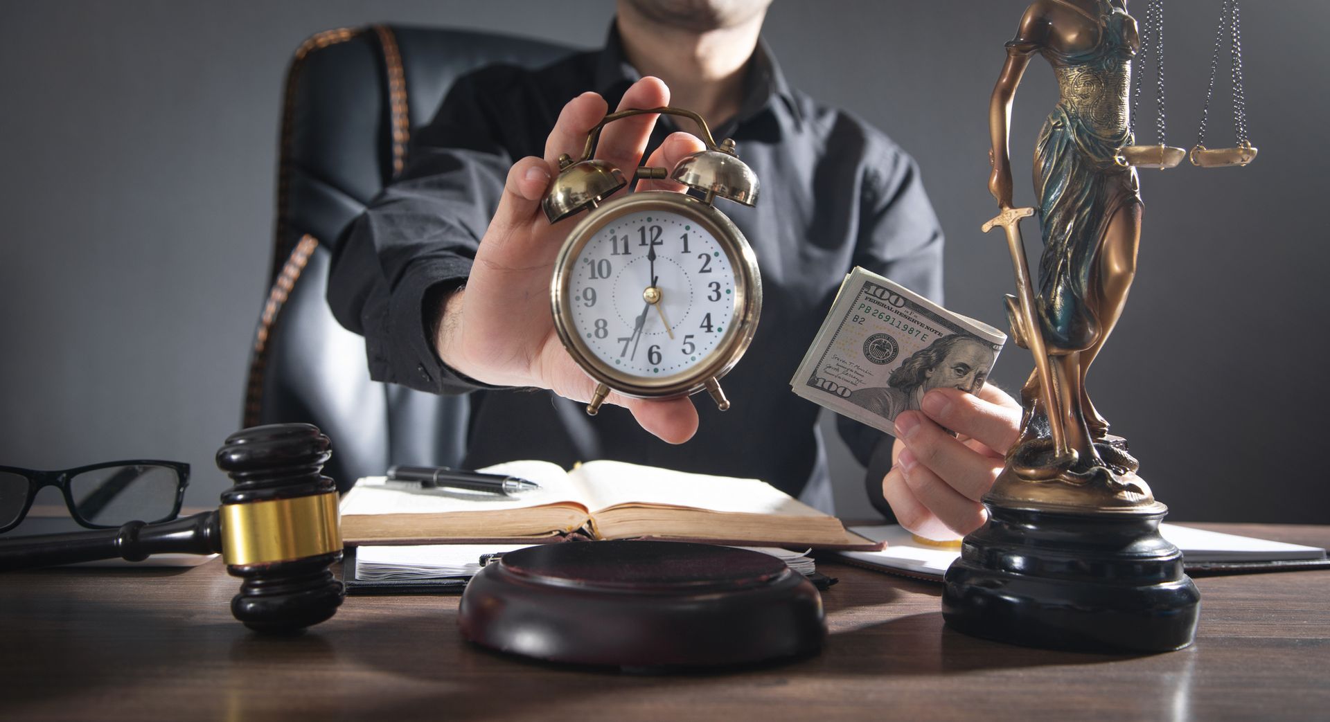 Lawyer holding alarm clock and money near scales of justice and gavel.